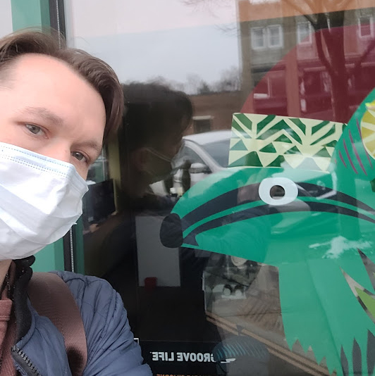 Michael Faehnel, owner of Squirrel City Jewelrs, outside the store with a green squirrel painted on the window. 