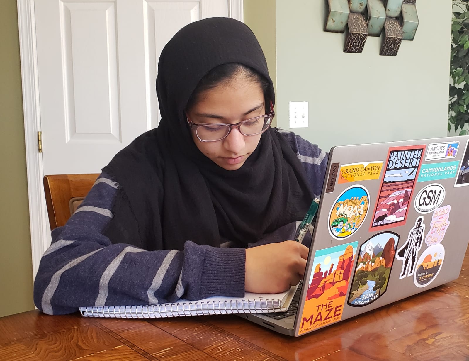 Isra studying at table