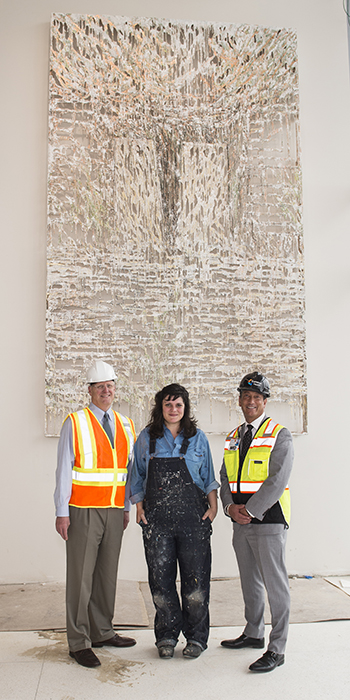 Alumna Diana Al-Hadid in front of her artwork installed at Summa Health Systems