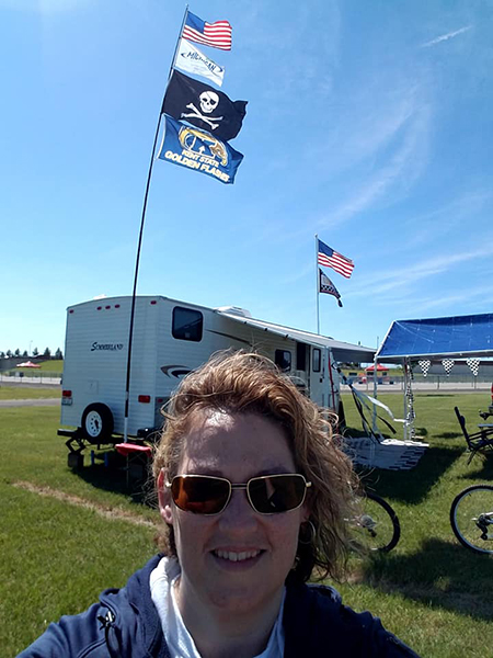 Kerry Angle, senior business manager for the Kent Student Center, proudly flies the Kent State flag (in the background) during her yearly vacation to the Michigan International Speedway for the annual June NASCAR series race week. Kerry Angle, senior business manager for the Kent Student Center, proudly flies the Kent State flag (in the background) during her yearly vacation to the Michigan International Speedway for the annual June NASCAR series race week.