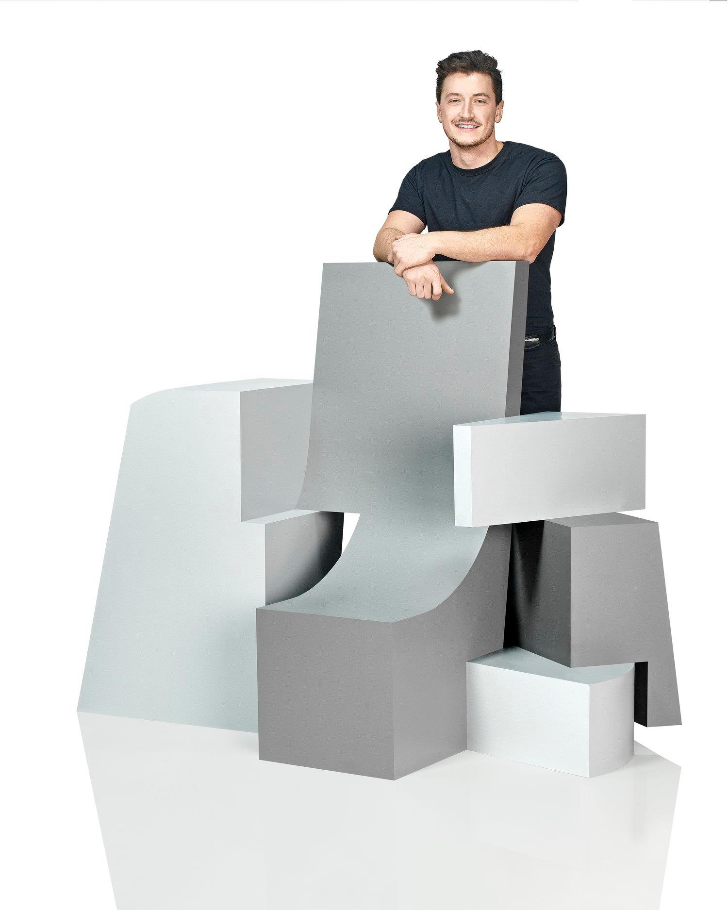 Student Greg Genter posing with his chair design