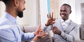 Two students talking via sign language.