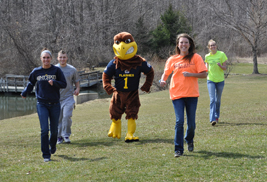 Flash, the official ѿappmascot, led a few students through parts of the course that has been mapped out for the first-ever Flash Dash, a 5K obstacle race at ѿappSalem, on May 18. Pictured with Flash are (from left) Jaclyn Gaines, Matt Richards, Meghan Skiba and Megan Kibler