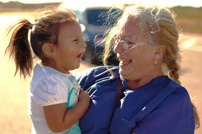 Lorene Martin with a Lakota child.