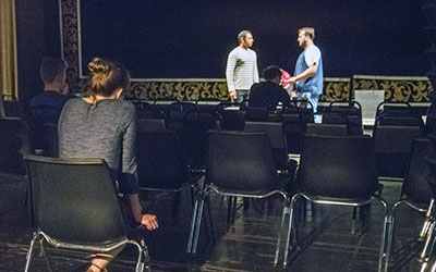 Sherin watches rehearsal from the audience.