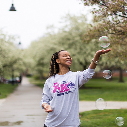 Student playing with bubbles