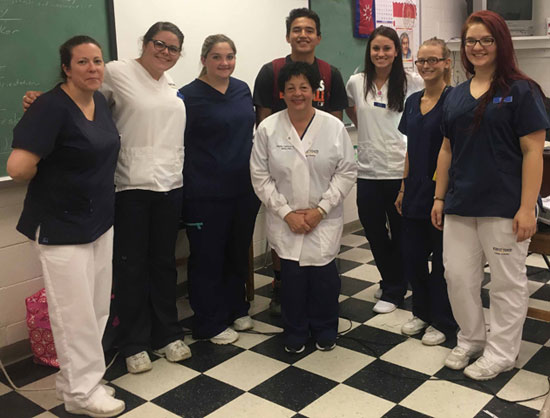 Nursing students with Phyllis DeFiore-Golden at a high school