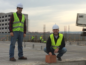 Hunsicker placing the first brick to start the building of Kosovo Leadership Academy