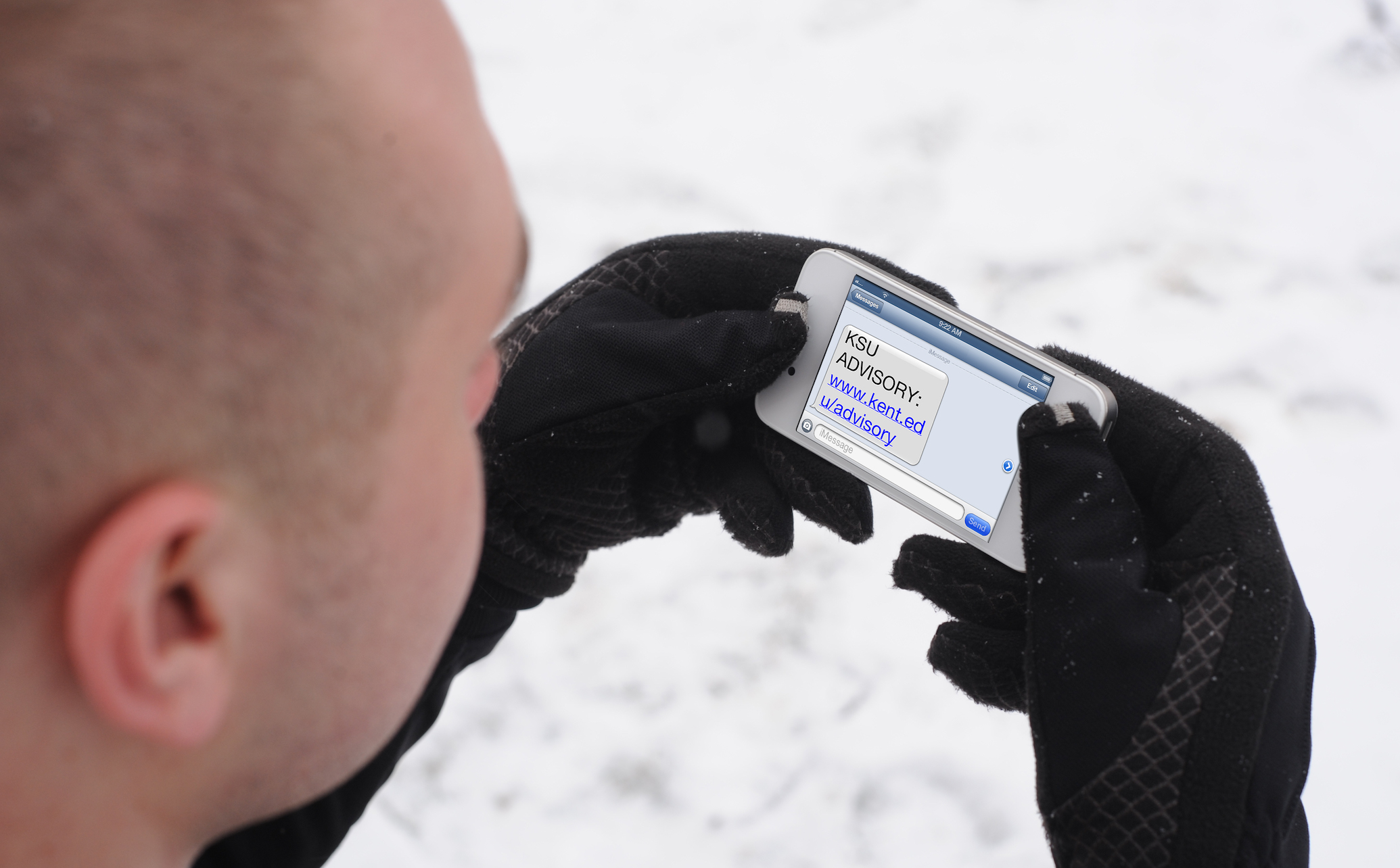 Թ State student receiving an alert on his mobile phone. 