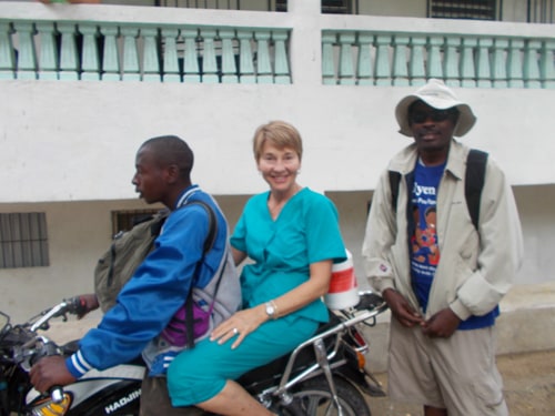 Brook Borgeson Gray rides a motorcycle to the Hatian mountain villages with a Hatian medical team