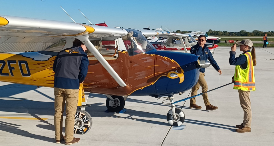Three students prepare an airplane for inspection at the NIFA SAFECON championships