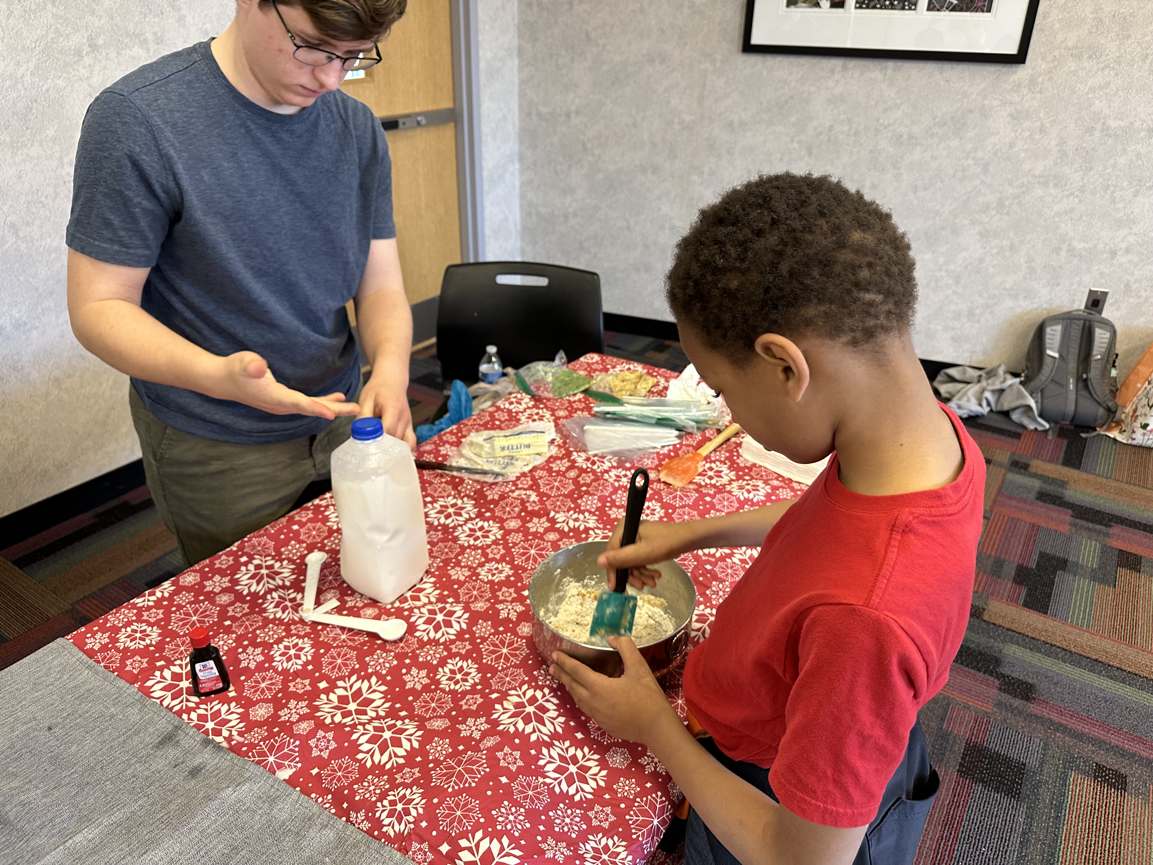 Kent State senior middle childhood education major Rowan Marusek helps a student with a recipe. Kent State senior middle childhood education major Rowan Marusek helps a student with a recipe.