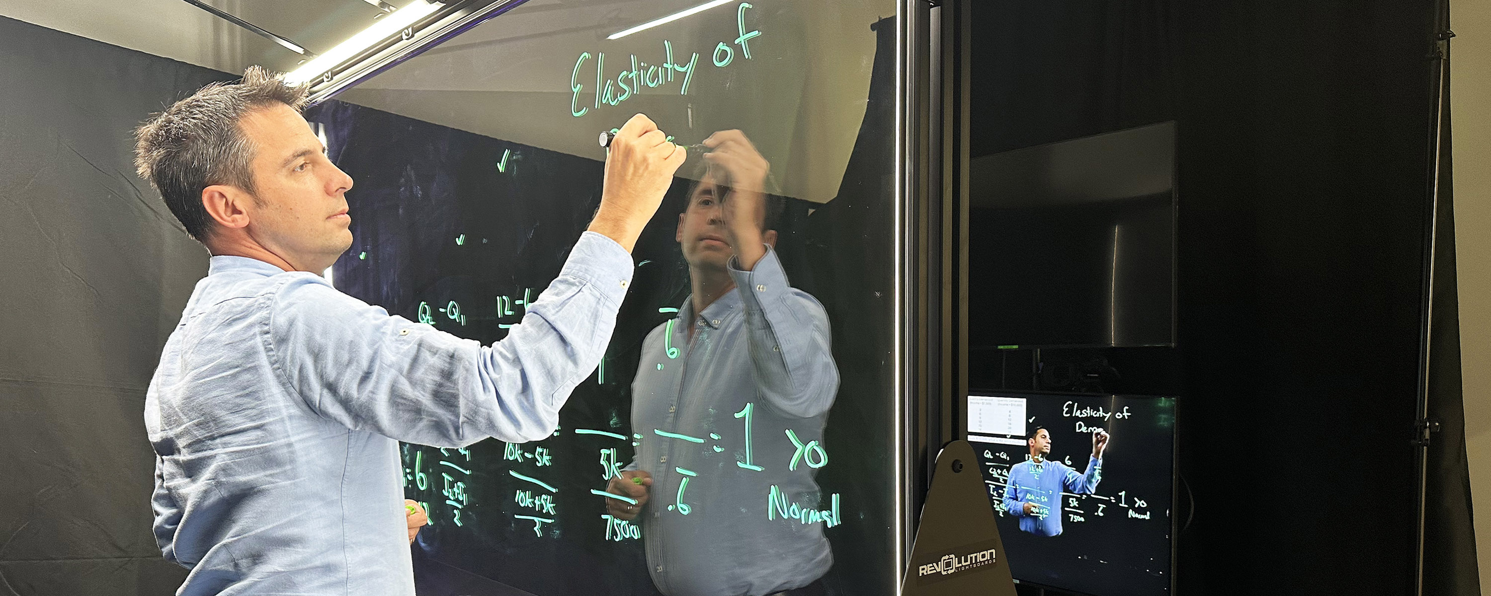 Shawn Rohlin, Ph.D., professor of economics, records a lecture for an online course in the Crawford Hall production studio.