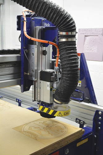 Digital router cutting a design out of wood