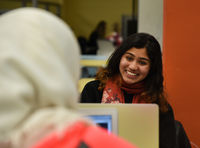 Student smiling at another