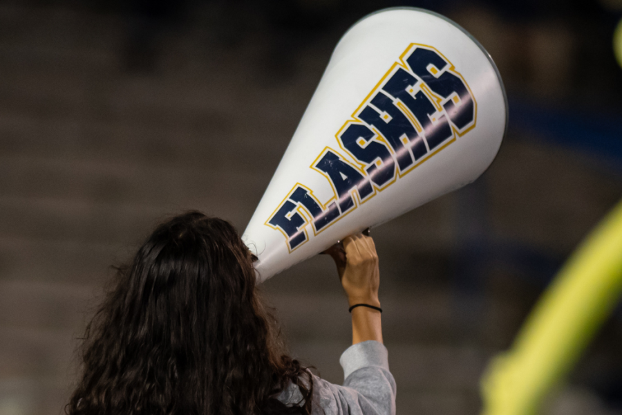A woman holds up a white megaphone that says Flashes