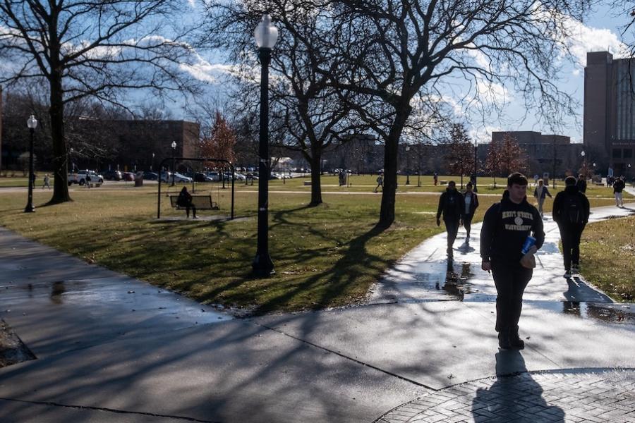 Students walk campus in January with long shadows