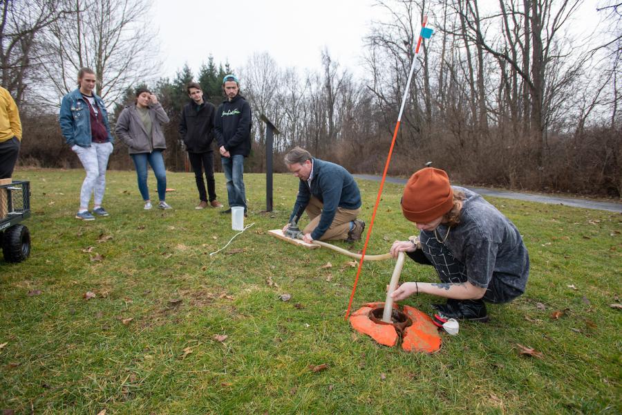 Students testing the levels of the water table at Kent State University at Stark