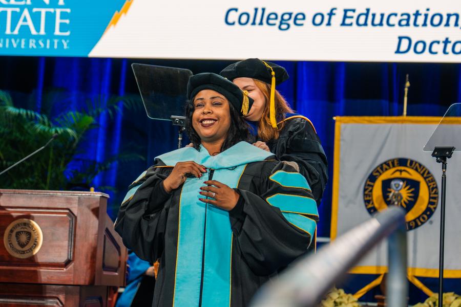 A doctoral graduate being hooded during the Fall 2025 commencement ceremony.