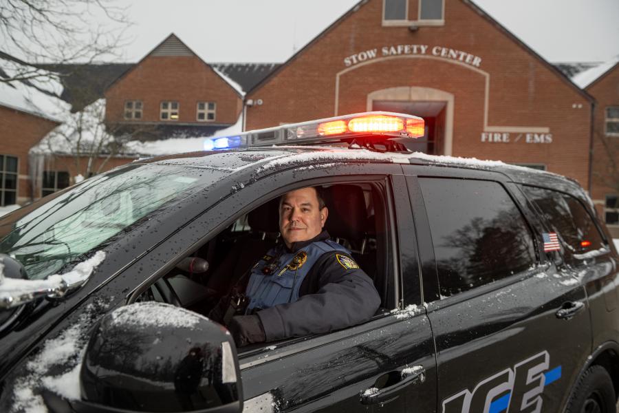 William Kalkhoff in a police cruiser in front of the Stow Police Department