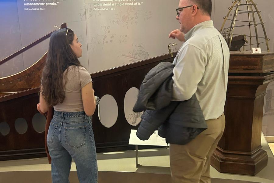 A KSU professor talk with a student in front of an exhibit in the Galileo Museum in Flornce, Italy.
