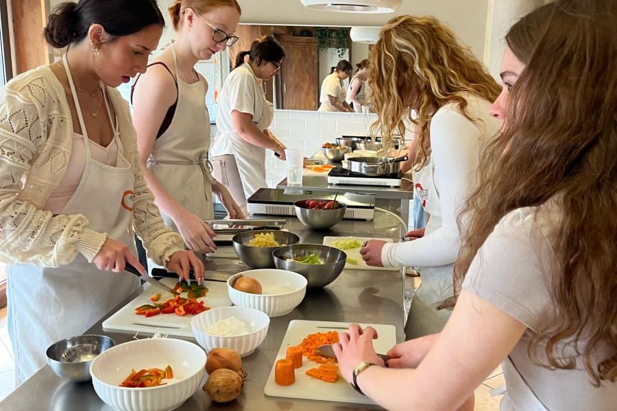 Exploratory students making food in a cooking class in Florence, Italy.