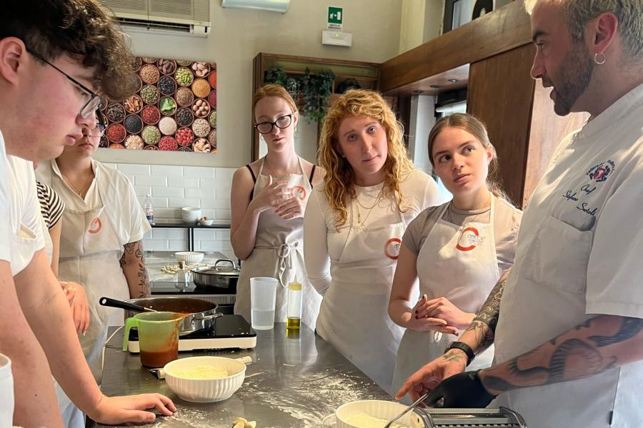 Exploratory students learn to make pasta in a cooking class in Florence, Italy.