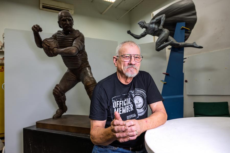 Dave Demming in his sculpture studio with statue of Thurman Munson