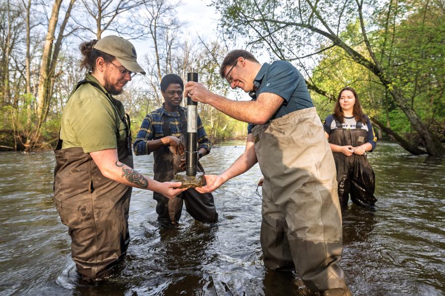 Professor Dave Costello works with biology students in the Cuyahoga River