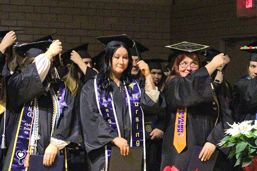 Ashtabula Campus graduates adjust their tassels at the Fall 2025 commencement ceremony