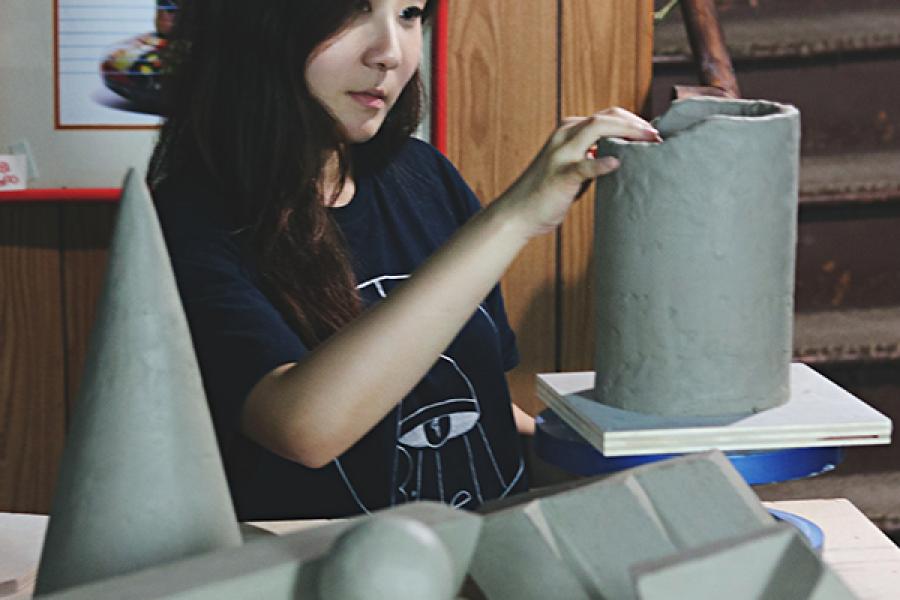 Photo of artist Audrey An working in her sculpture studio