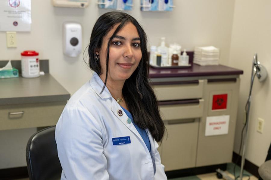 Ayat Husain, podiatric medicine student, in clinic room - photo credit Bob Christy 