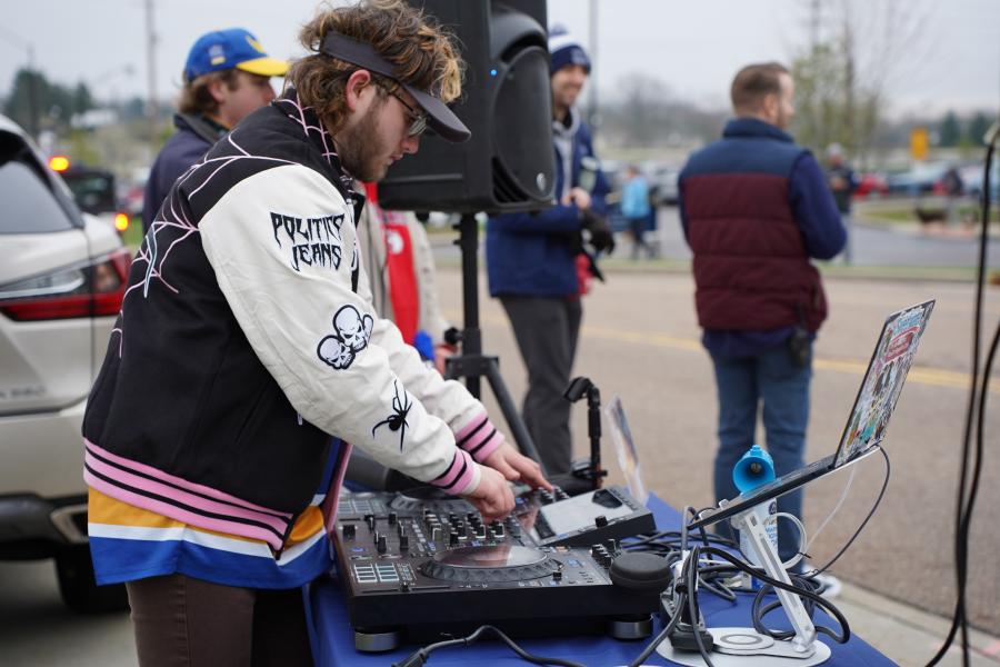 DJ turning discs while playing music