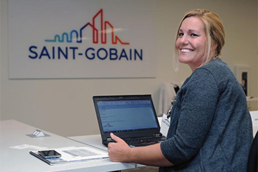 Smiling woman seated at a laptop
