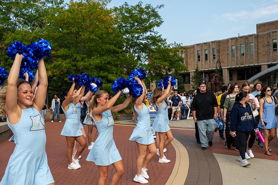 Group of dance members performing while students walk around Blastoff event on campus