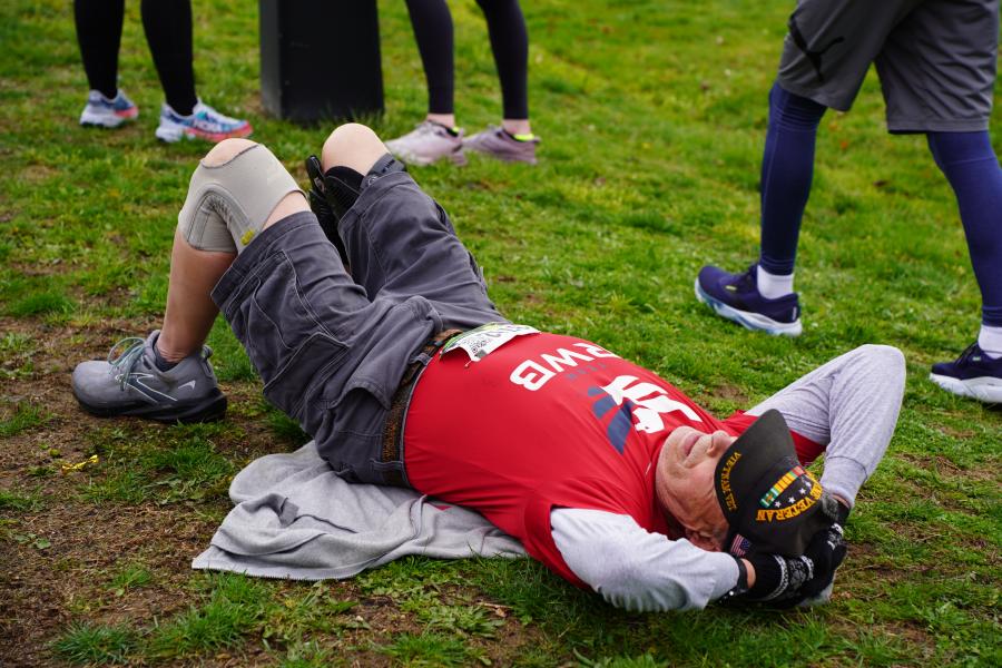 Man laying down in the grass relaxing after race