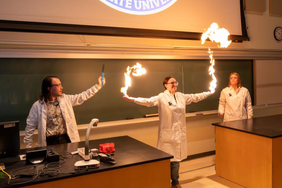 Stockroom employees perform the methane bubbles demonstration.