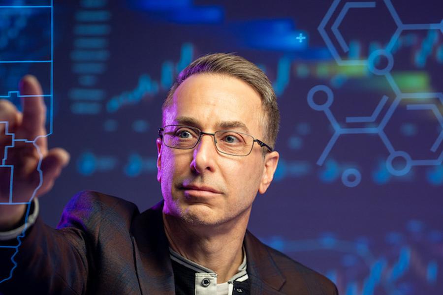 Deric Kenne, Ph.D., director of the Center for Public Policy and Health at Kent State University, reviews a map of Ohio. (Photo credit: Rami Daud, Kent State University)