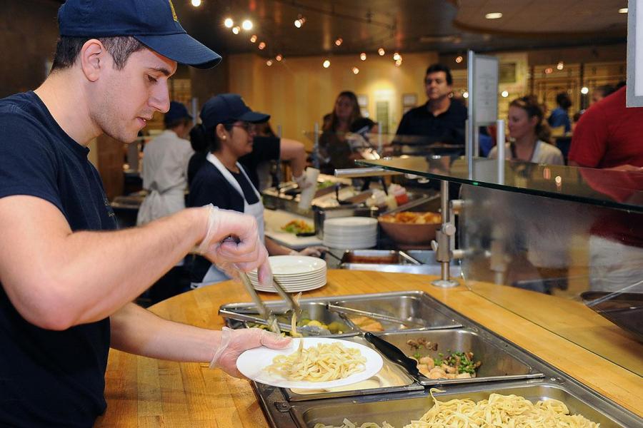 KSU Culinary Staff serving noodles behind a food screen
