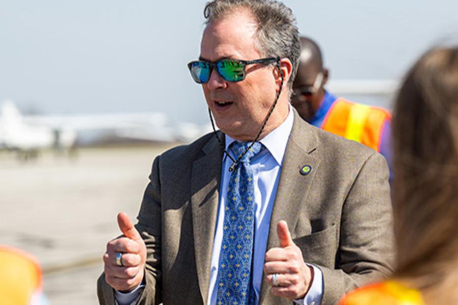 Erik Amend gives two thumbs up to students at the KSU airport