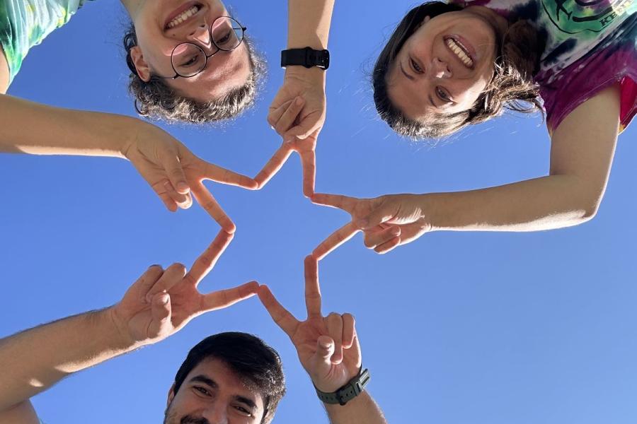 Gabriel and friends making a star with their hands