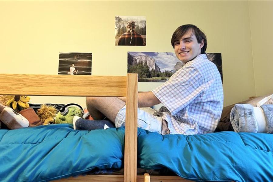 Honors student Lucas Hlavacek sittings in his residence hall room at .
