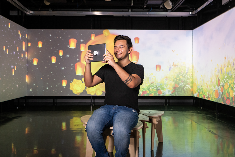 A student uses an iPad to engage in an AR experience at the DI Hub.