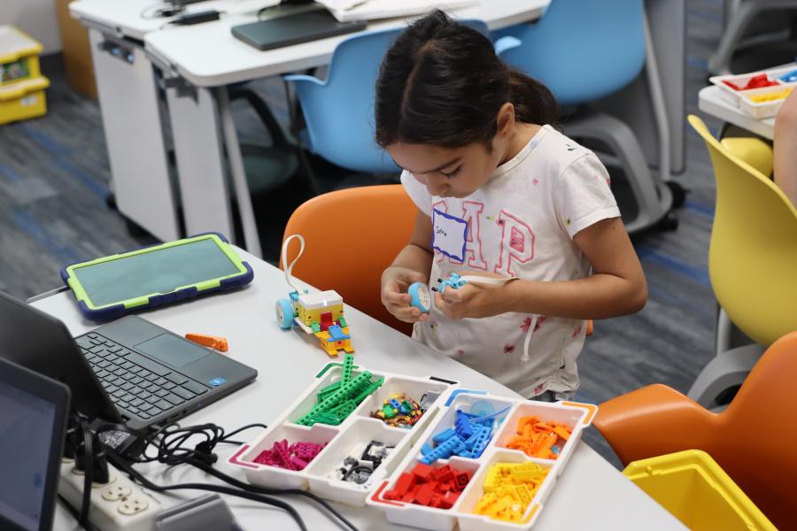 Girl building something with legos
