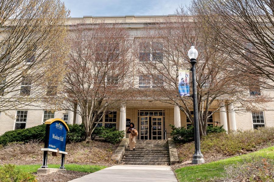 Student walking in front of Moulton Hall