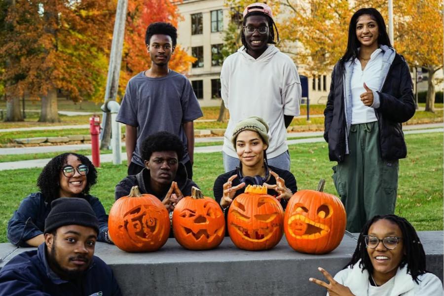 Toby and members of NOMAS pose with carved pumpkins.