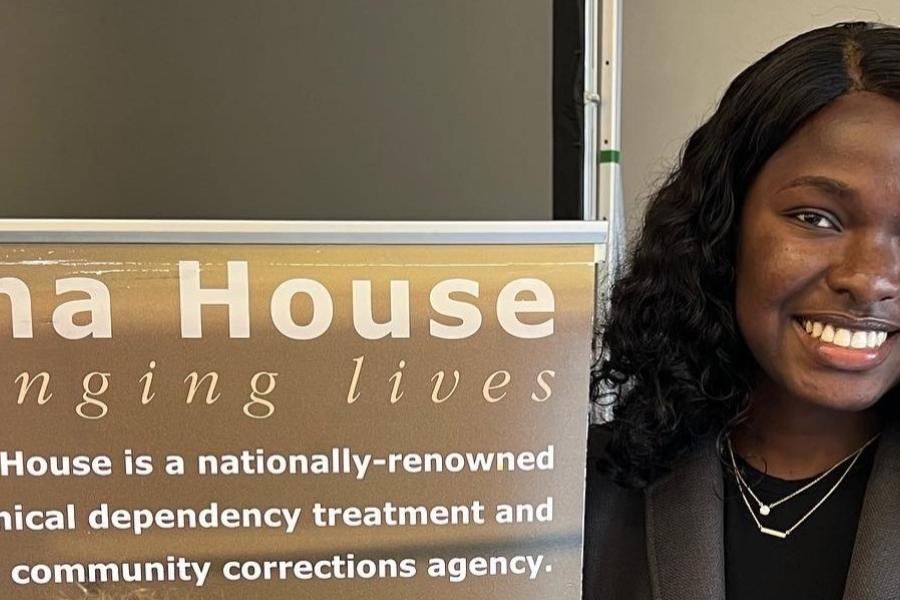 CPH alumna with Oriana House banner