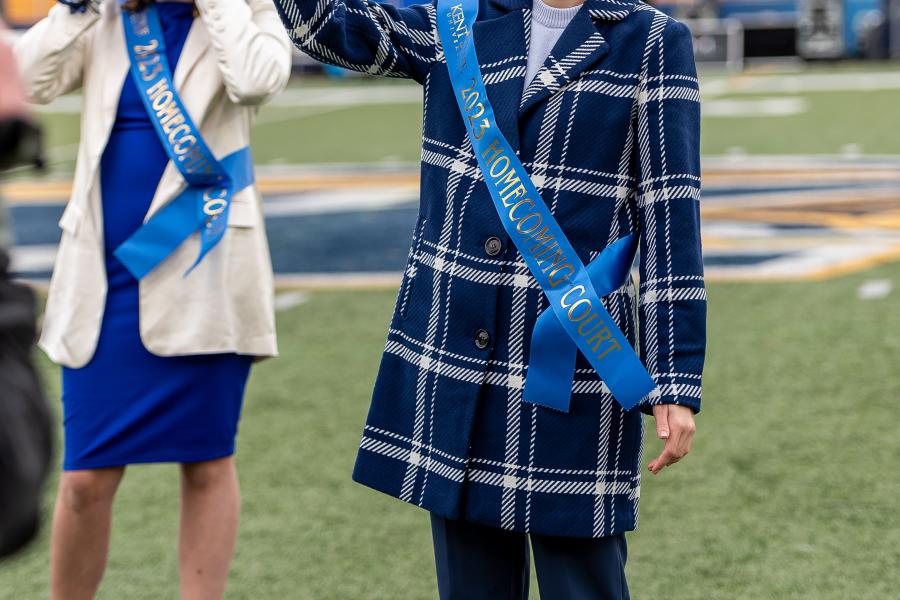 Rachel Warino on football field wearing blue homecoming sash.