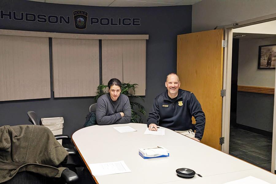 EMAT student sitting in Hudson Police office with chief