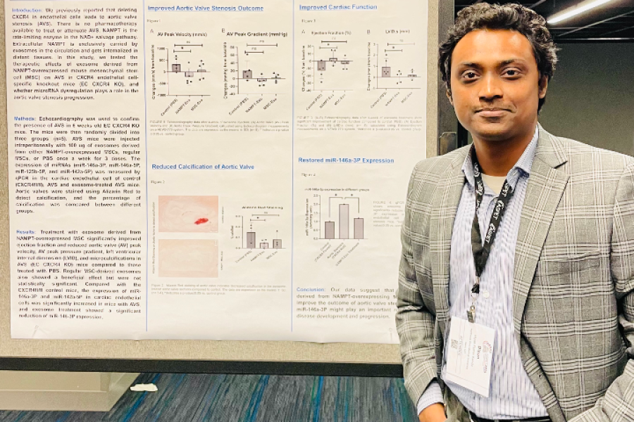 Student standing in front of poster